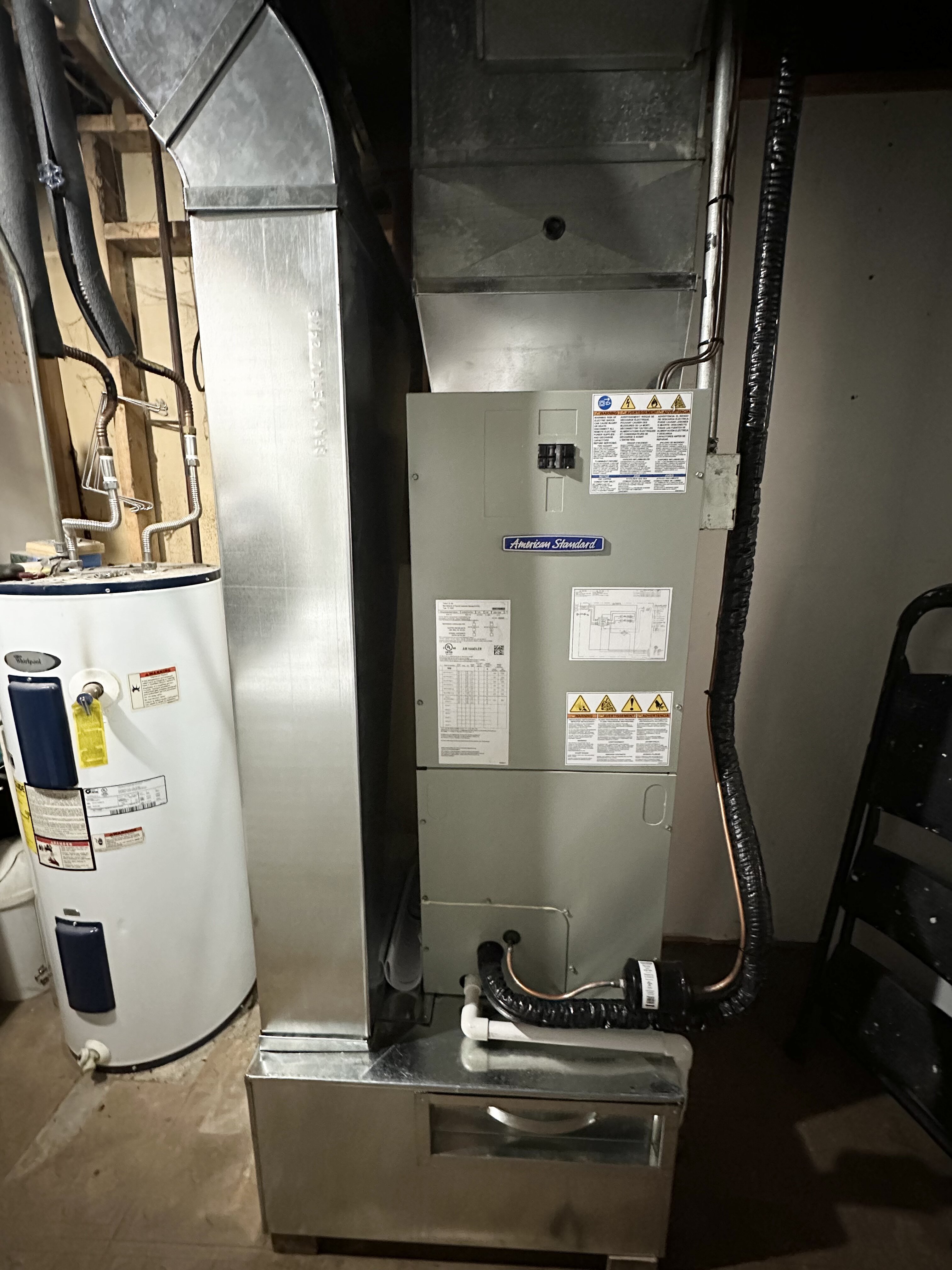 American Standard furnace and water heater in a basement